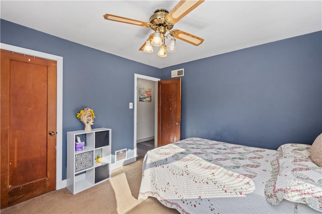 231 Rehoboth Church Road Perryopolis, PA 15473 - Photo 16 of 25 a bedroom with a bed and a chandelier