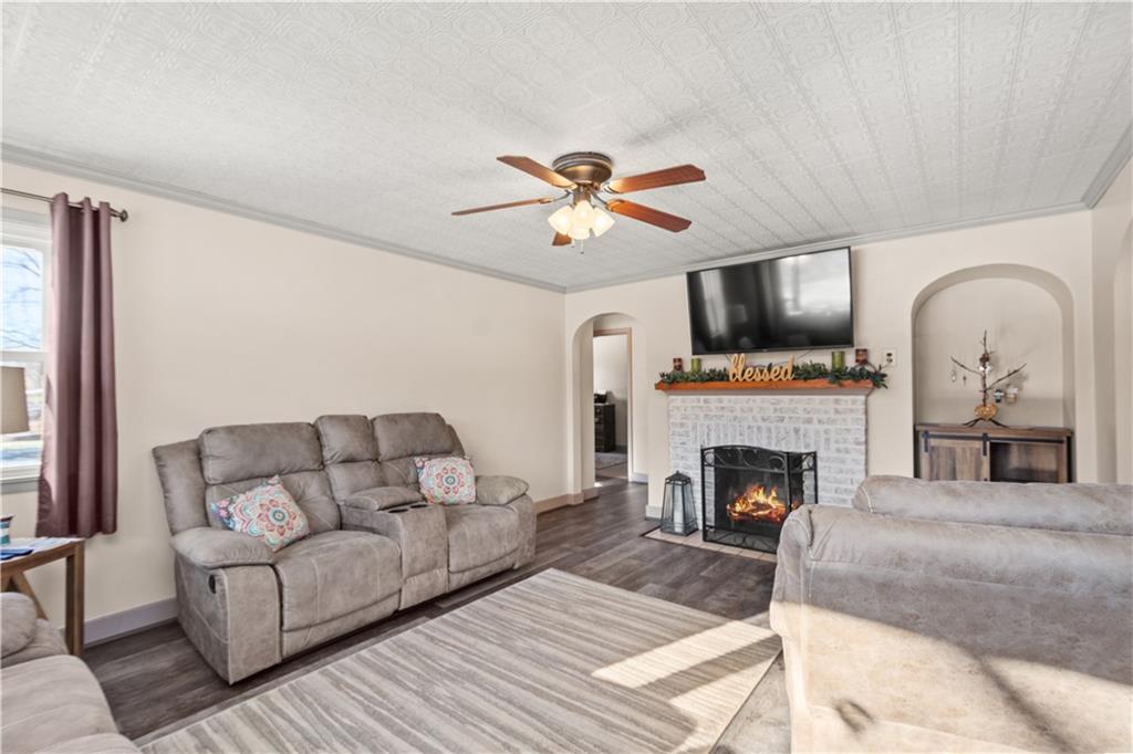 231 Rehoboth Church Road Perryopolis, PA 15473 - Photo 5 of 25 a living room with furniture a fireplace and a flat screen tv
