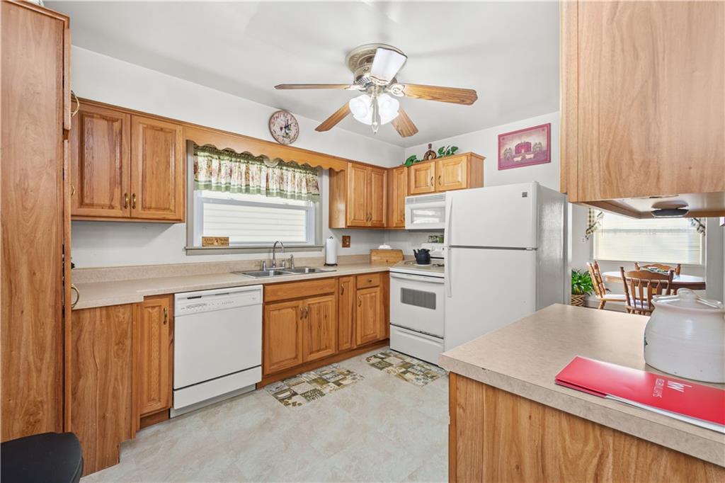 231 Rehoboth Church Road Perryopolis, PA 15473 - Photo 8 of 25 a kitchen with granite countertop a refrigerator a stove a sink dishwasher and a microwave oven