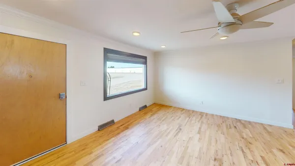 wooden floor in an empty room with a window
