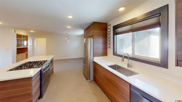 a kitchen with stainless steel appliances granite countertop a sink stove and refrigerator