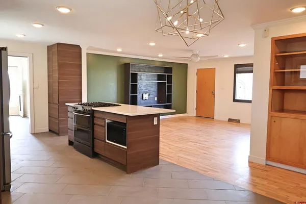 a kitchen with stainless steel appliances granite countertop a stove and a refrigerator