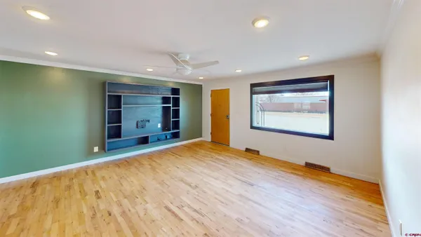 a view of an empty room with a closet and a window