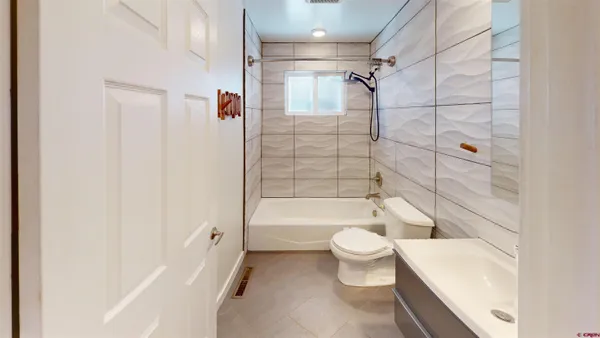 a bathroom with a toilet a sink and bathtub