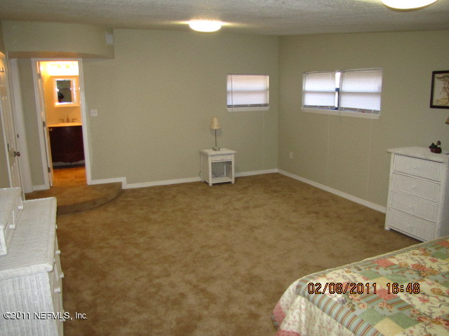 10459 Rutgers Road Jacksonville, FL 32218 - Photo 17 of 28 a bedroom with a bed and a window