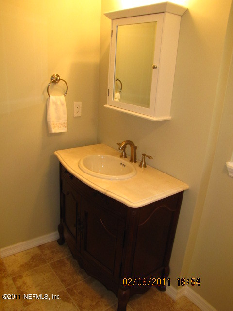 10459 Rutgers Road Jacksonville, FL 32218 - Photo 22 of 28 a bathroom with a sink and a mirror