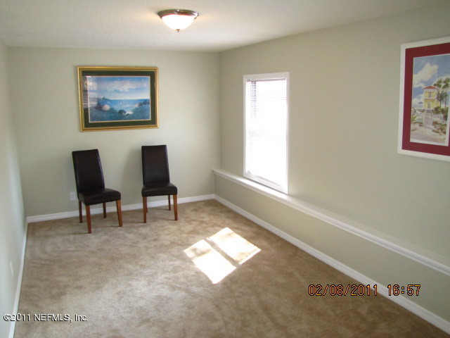 10459 Rutgers Road Jacksonville, FL 32218 - Photo 24 of 28 a living room with furniture and a window