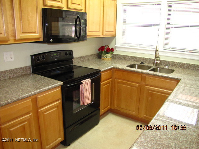 10459 Rutgers Road Jacksonville, FL 32218 - Photo 4 of 28 a kitchen with a sink stove top oven and microwave