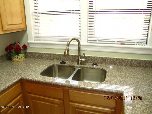 10459 Rutgers Road Jacksonville, FL 32218 - Photo 5 of 28 a kitchen with a sink cabinets and a window