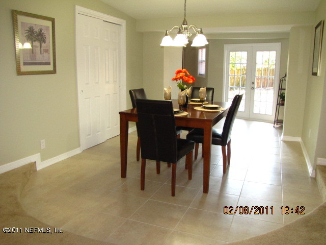 10459 Rutgers Road Jacksonville, FL 32218 - Photo 8 of 28 a view of a dining room with furniture and a chandelier
