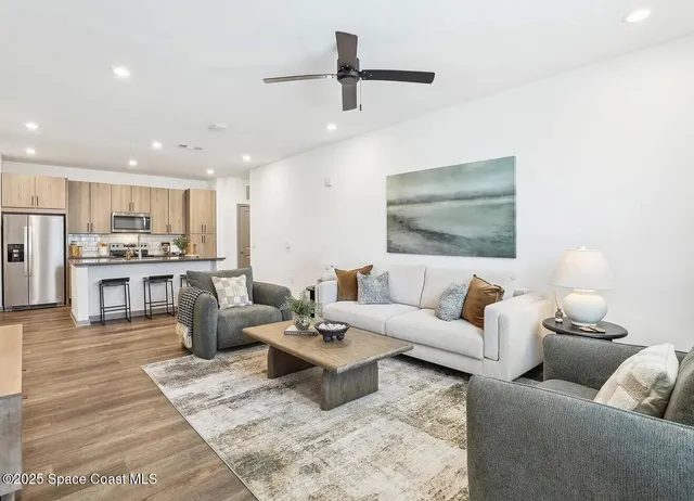 a living room with furniture and kitchen view