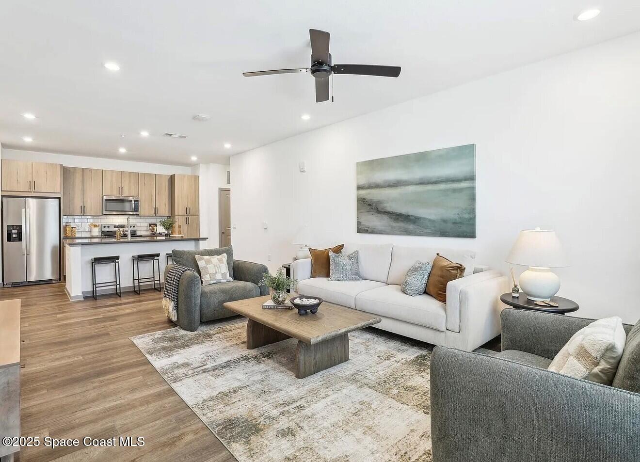 1073 Journey Circle, Unit 107 Rockledge, FL 32955 - Photo 5 of 10 a living room with furniture and kitchen view