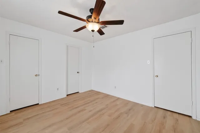 a view of a room with wooden floor