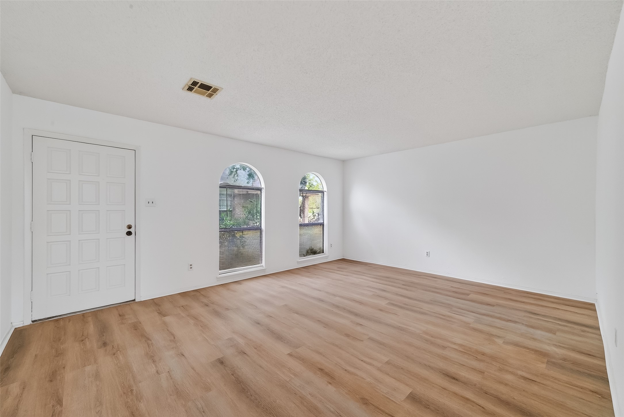 7861 Cook Road Houston, TX 77072 - Photo 5 of 20 a view of an empty room with window and wooden floor