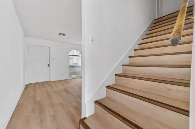 a view of staircase with white walls