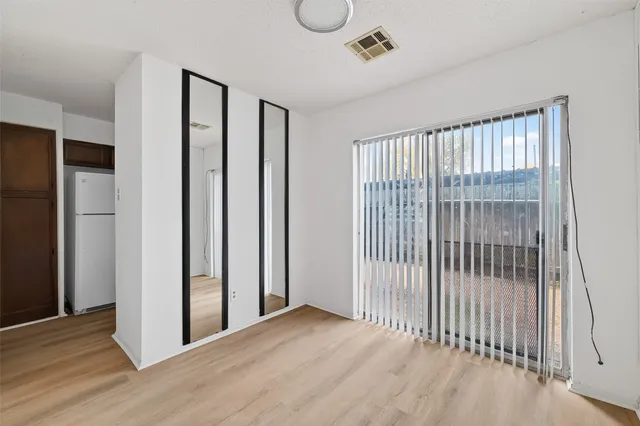 a view of a room with wooden floor and windows