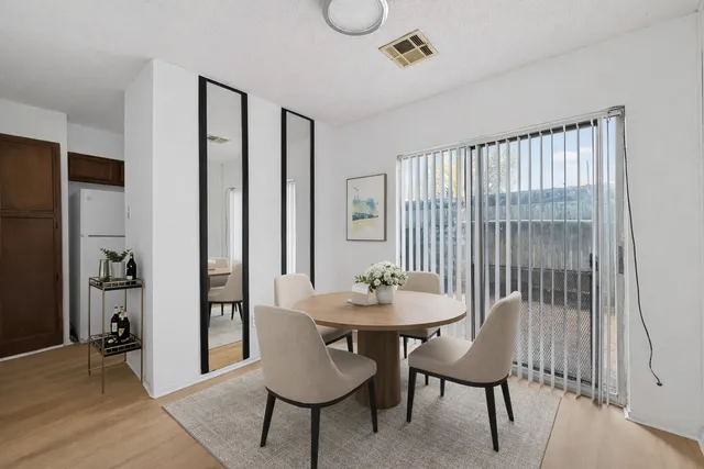 a dining room with furniture and window