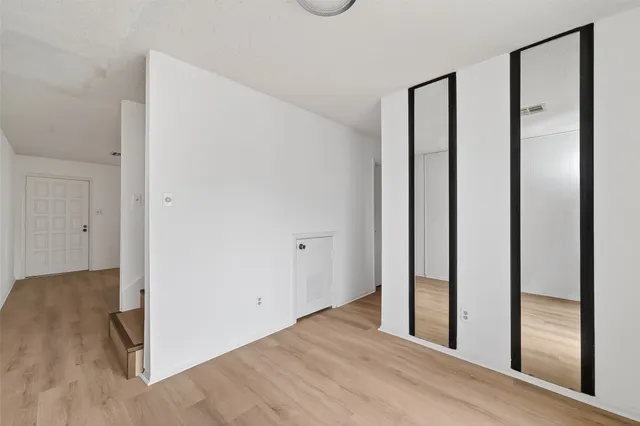 a view of a room with wooden floor