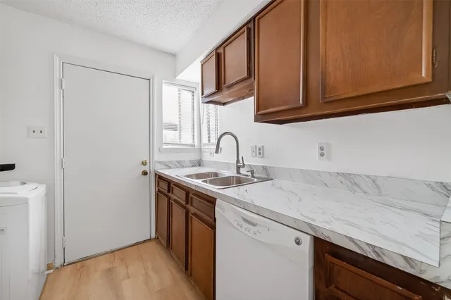 a kitchen with stainless steel appliances granite countertop a sink and a microwave