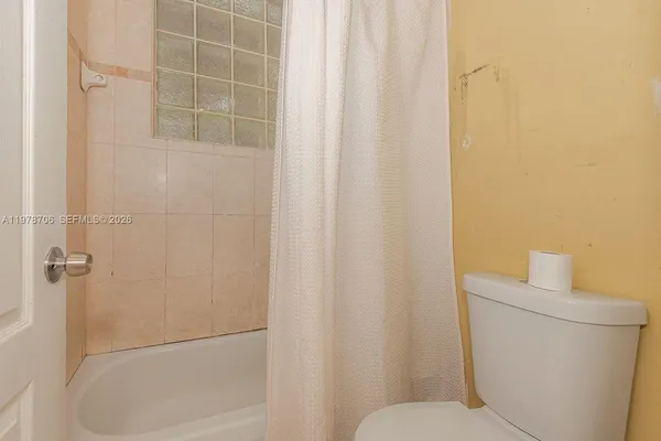 a bathroom with a shower and a toilet
