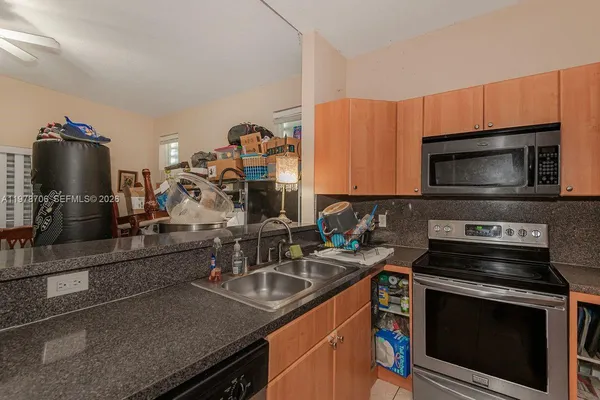 a kitchen with a sink stove and microwave