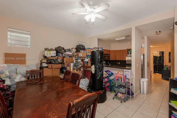 a living room with lots of furniture and a view of kitchen