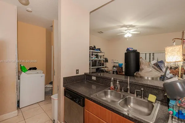a kitchen with stainless steel appliances granite countertop a sink and a refrigerator