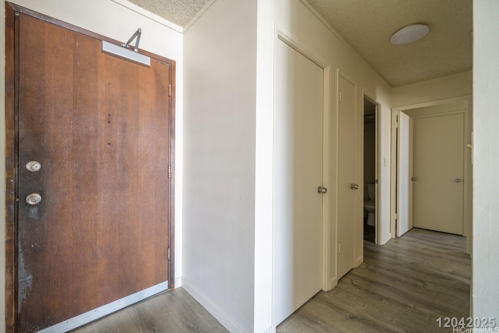3161 Ala Ilima Street, Unit 1403 Honolulu, HI 96818 - Photo 12 of 24 a view of a bathroom with wooden floor