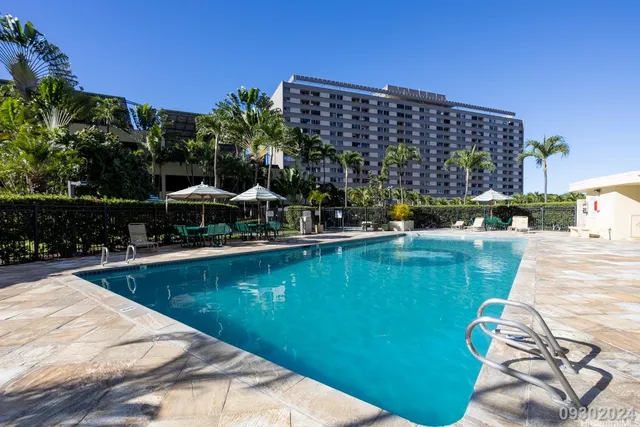 a view of swimming pool with outdoor seating and plants