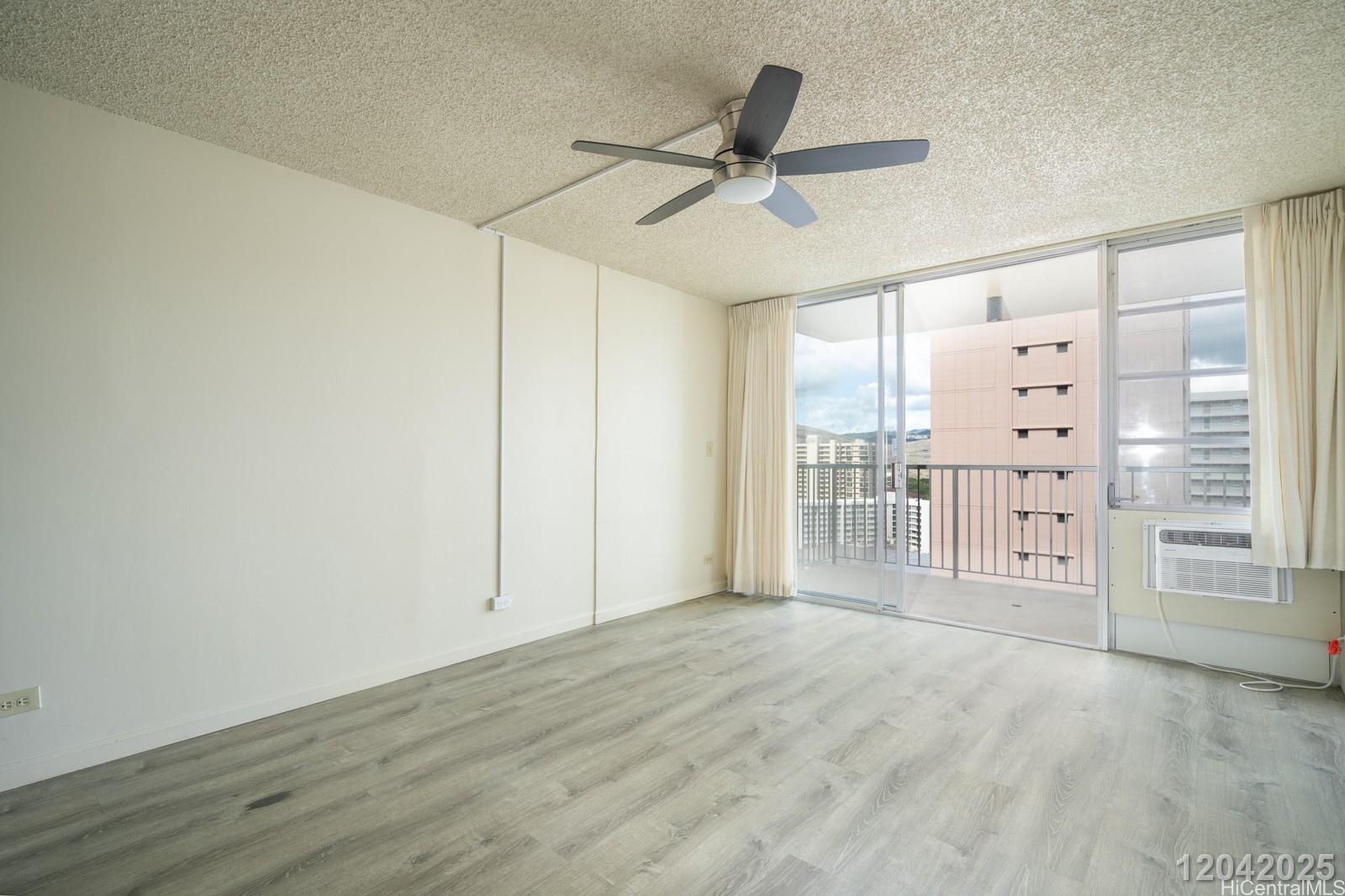 3161 Ala Ilima Street, Unit 1403 Honolulu, HI 96818 - Photo 3 of 24 a view of a livingroom with a ceiling fan & entryway