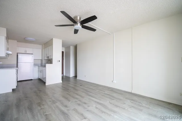 a view of a refrigerator in kitchen and wooden floor