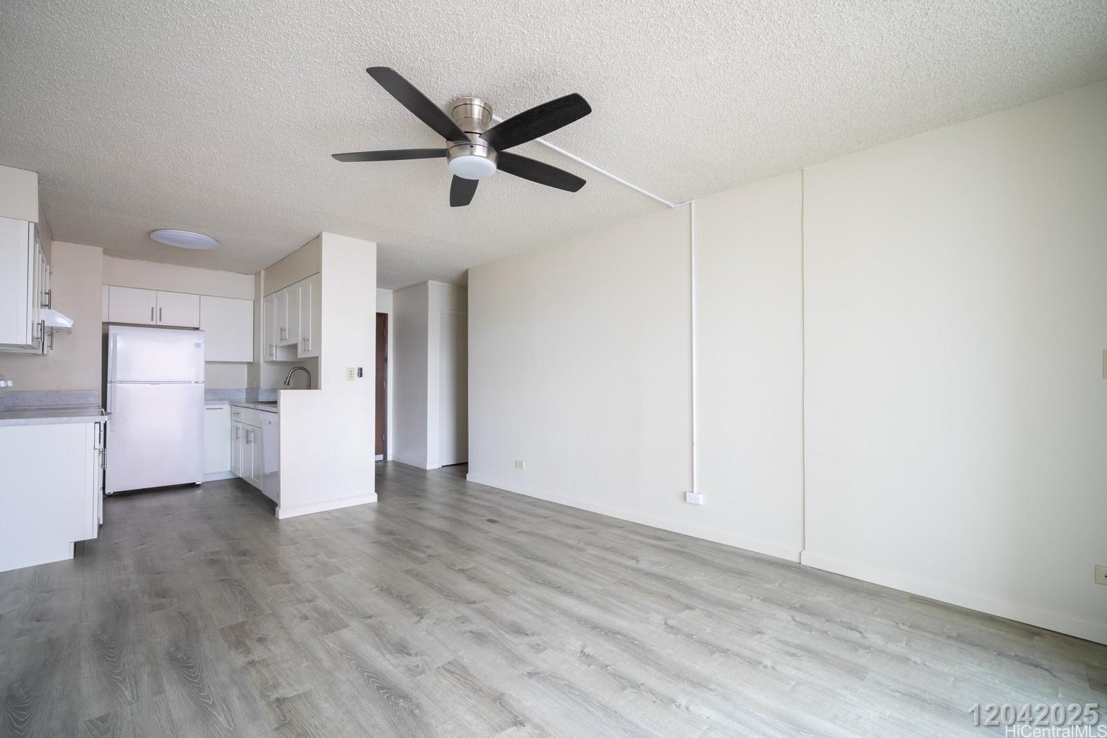 3161 Ala Ilima Street, Unit 1403 Honolulu, HI 96818 - Photo 7 of 24 a view of a refrigerator in kitchen and wooden floor