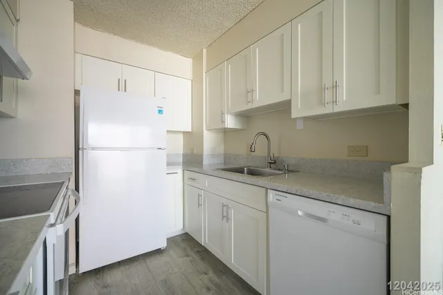 a white refrigerator freezer sitting inside of a kitchen