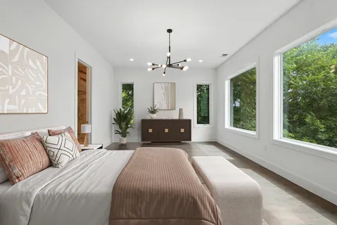 a bedroom with a large bed and a large window