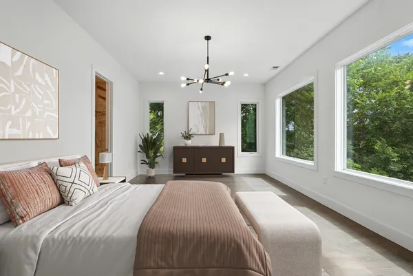 a bedroom with a large bed and a large window