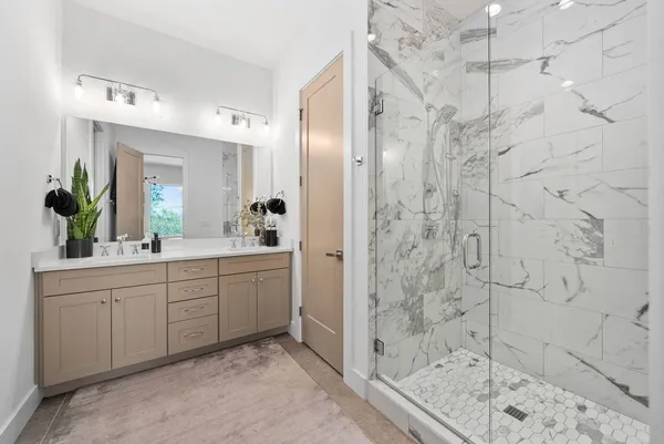 a spacious bathroom with a shower sink and mirror