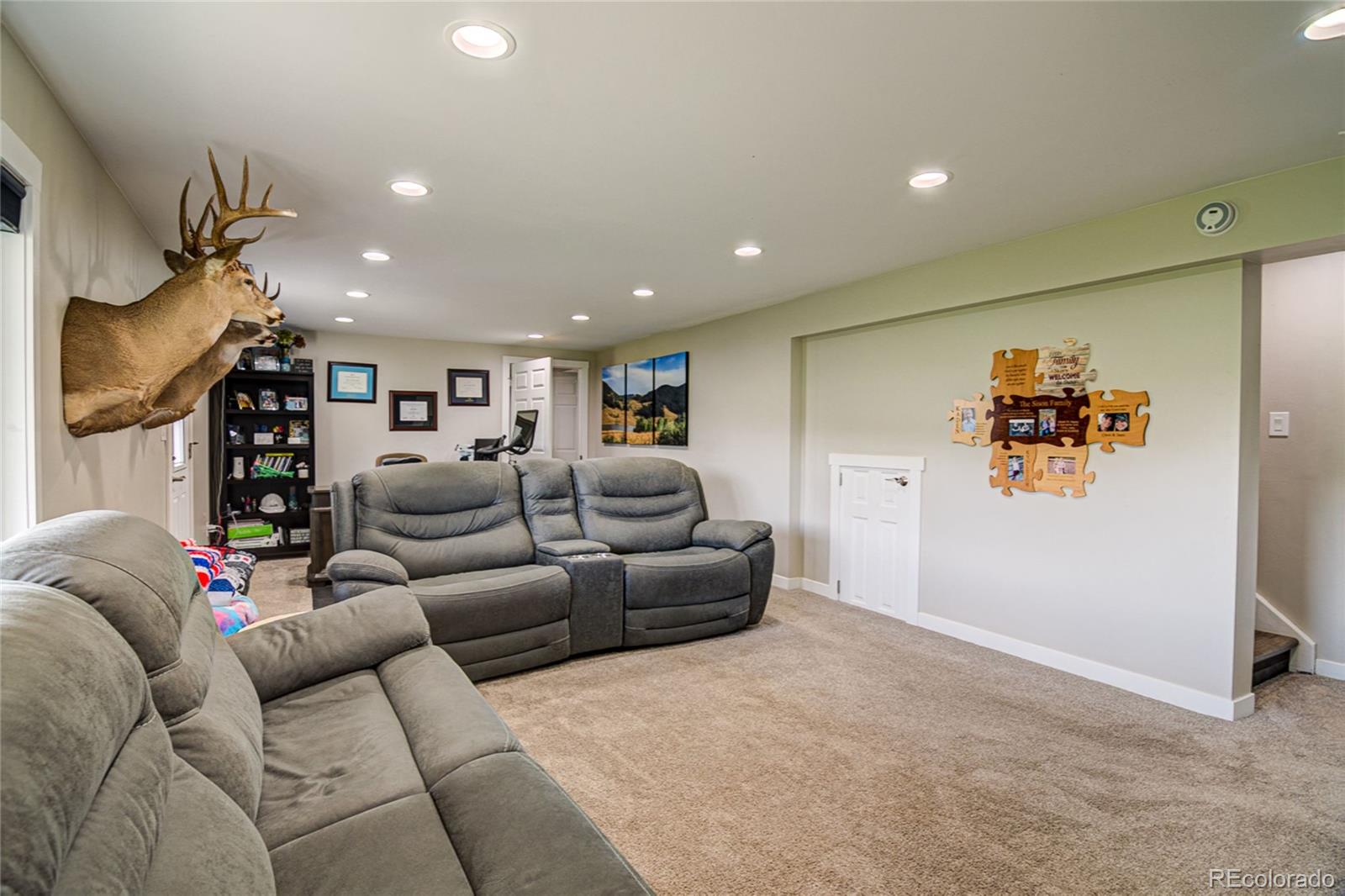 4531 East Best Road Larkspur, CO 80118 - Photo 26 of 49 a living room with furniture and a flat screen tv