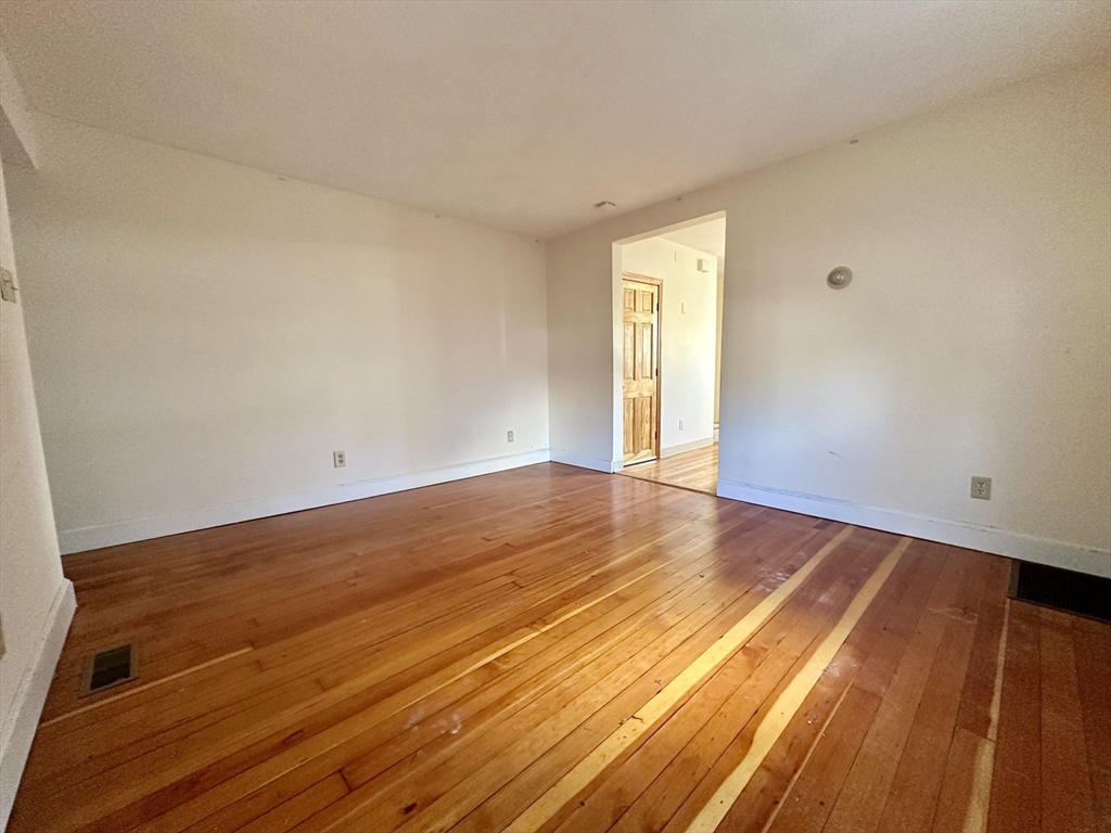 5 Rifle Court, Unit 5 Watertown, MA 02472 - Photo 4 of 14 a view of an empty room with wooden floor and a window