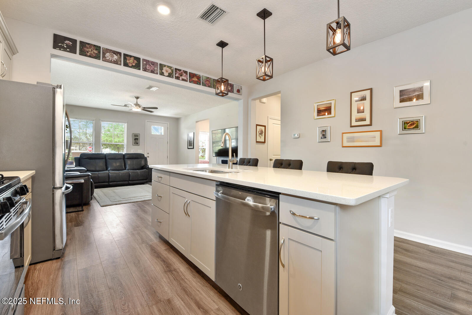 134 Jackrabbit Trail Ponte Vedra, FL 32081 - Photo 11 of 26 a kitchen with a sink dishwasher a stove and a refrigerator with wooden floor