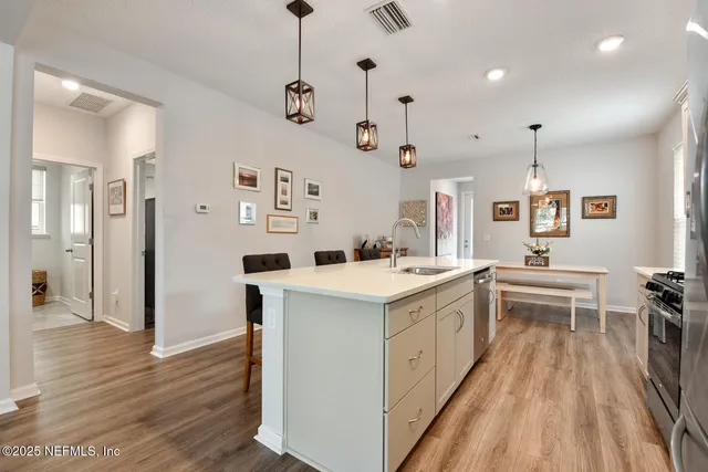 a kitchen with a sink stove and refrigerator
