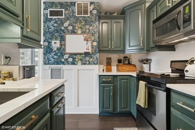 a kitchen with stainless steel appliances a sink and cabinets