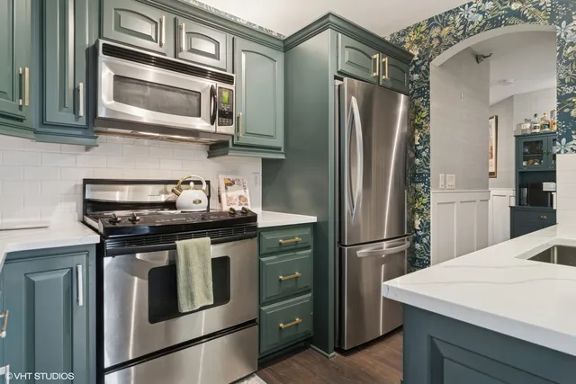 a kitchen with stainless steel appliances granite countertop a stove and a sink