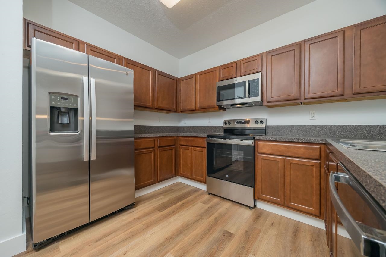 2310 Golden Lake Loop St. Augustine, FL 32084 - Photo 13 of 34 a kitchen with stainless steel appliances granite countertop a stove a sink and a refrigerator