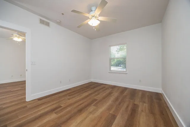 wooden floor in an empty room with a window