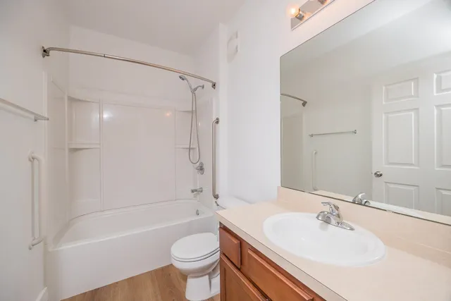a bathroom with a sink mirror toilet and bathtub