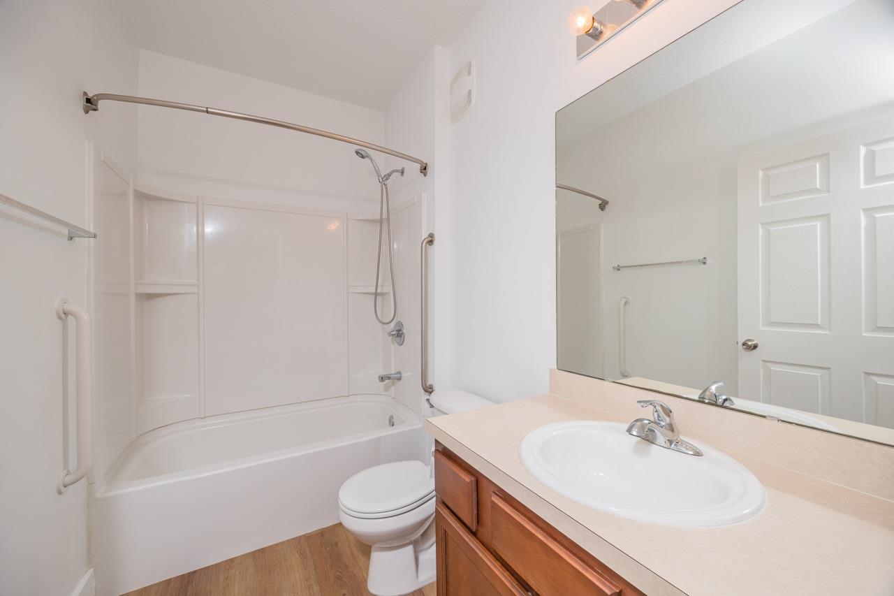 2310 Golden Lake Loop St. Augustine, FL 32084 - Photo 17 of 34 a bathroom with a sink mirror toilet and bathtub