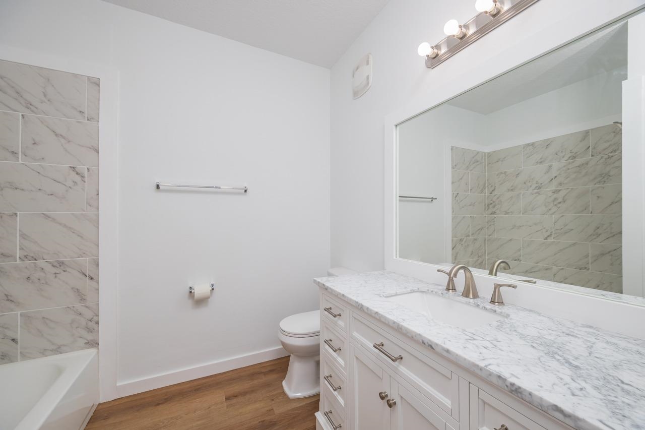 2310 Golden Lake Loop St. Augustine, FL 32084 - Photo 21 of 34 a bathroom with a granite countertop sink a toilet and shower