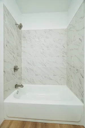 a bathroom with a bathtub and shower