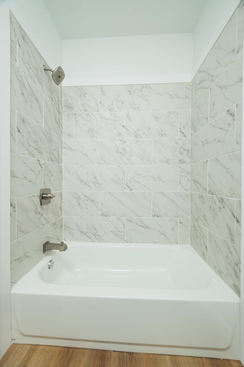 2310 Golden Lake Loop St. Augustine, FL 32084 - Photo 22 of 34 a bathroom with a bathtub and shower