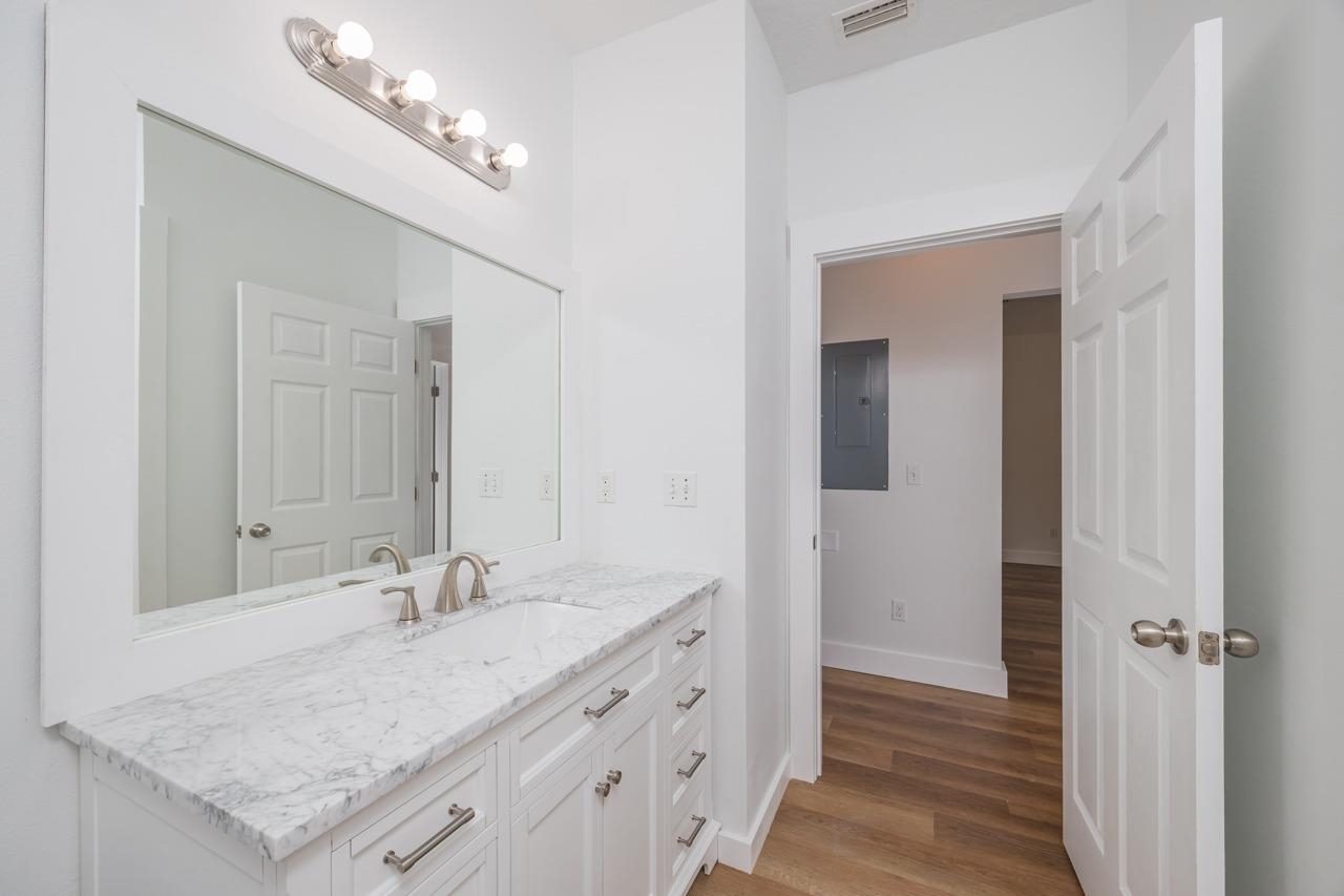 2310 Golden Lake Loop St. Augustine, FL 32084 - Photo 23 of 34 a bathroom with a granite countertop sink and a mirror